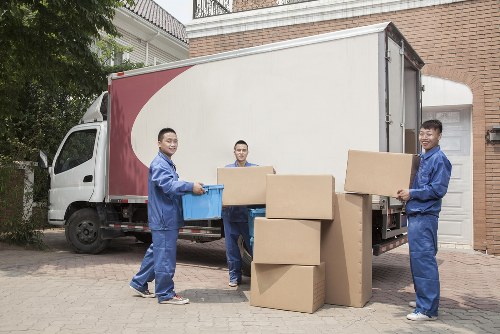 Local man and van removal team loading furniture in Maidavale