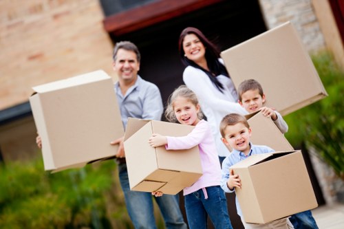Careful moving team handling boxes and furniture for home removals