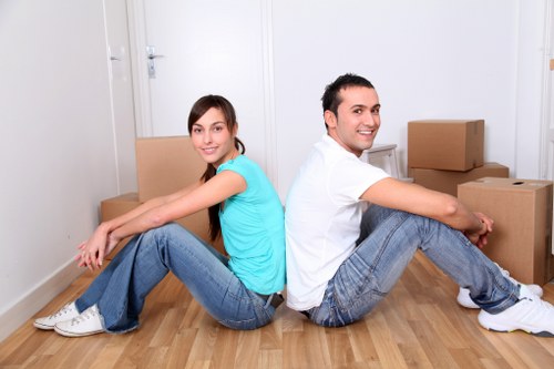 Professional movers handling boxes and furniture in a Maidavale home