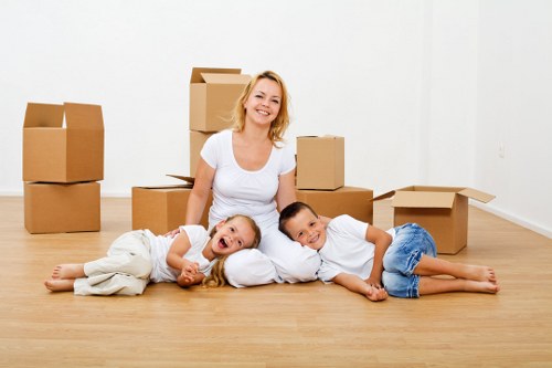 Mover wearing PPE while handling heavy household items