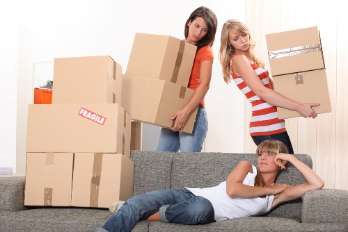 Local movers organising packed boxes during a Maidavale property move
